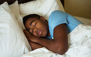 A boy sleeping in bed