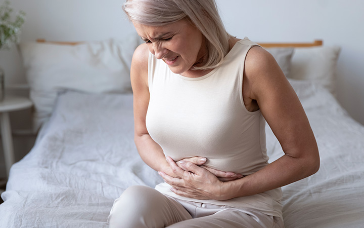 woman in pain holding stomach