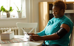woman checks blood pressure at home